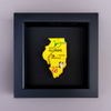 Yellow map of Illinois with cities on a black background in a black frame.
