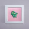 Framed artwork of a green map of Wisconsin on a pink background